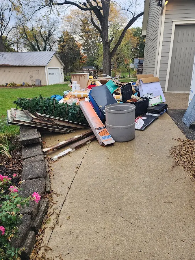 Dumpster being loaded with debris for Commercial Dumpster Rental in Madras
